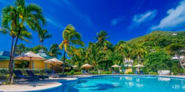 Swimming Pool and palm trees at Bequia Beach Hotel, Grenadines